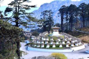 Dochula Pass, with the backdrop of a pristine forest in the snow covered Himalayan mountains, a popular stop on Bhutan holiday packages.